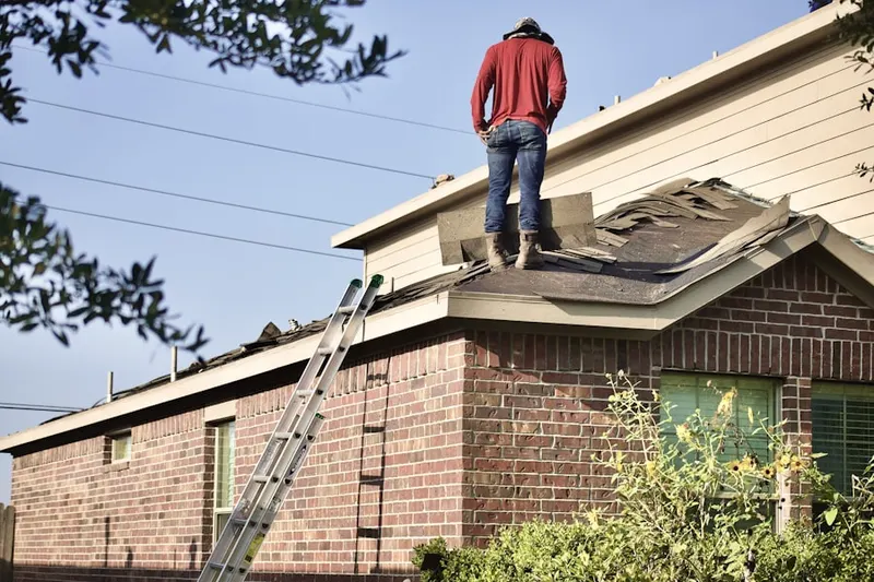 Professional roofer working on a residential roof in Stone Mill Run